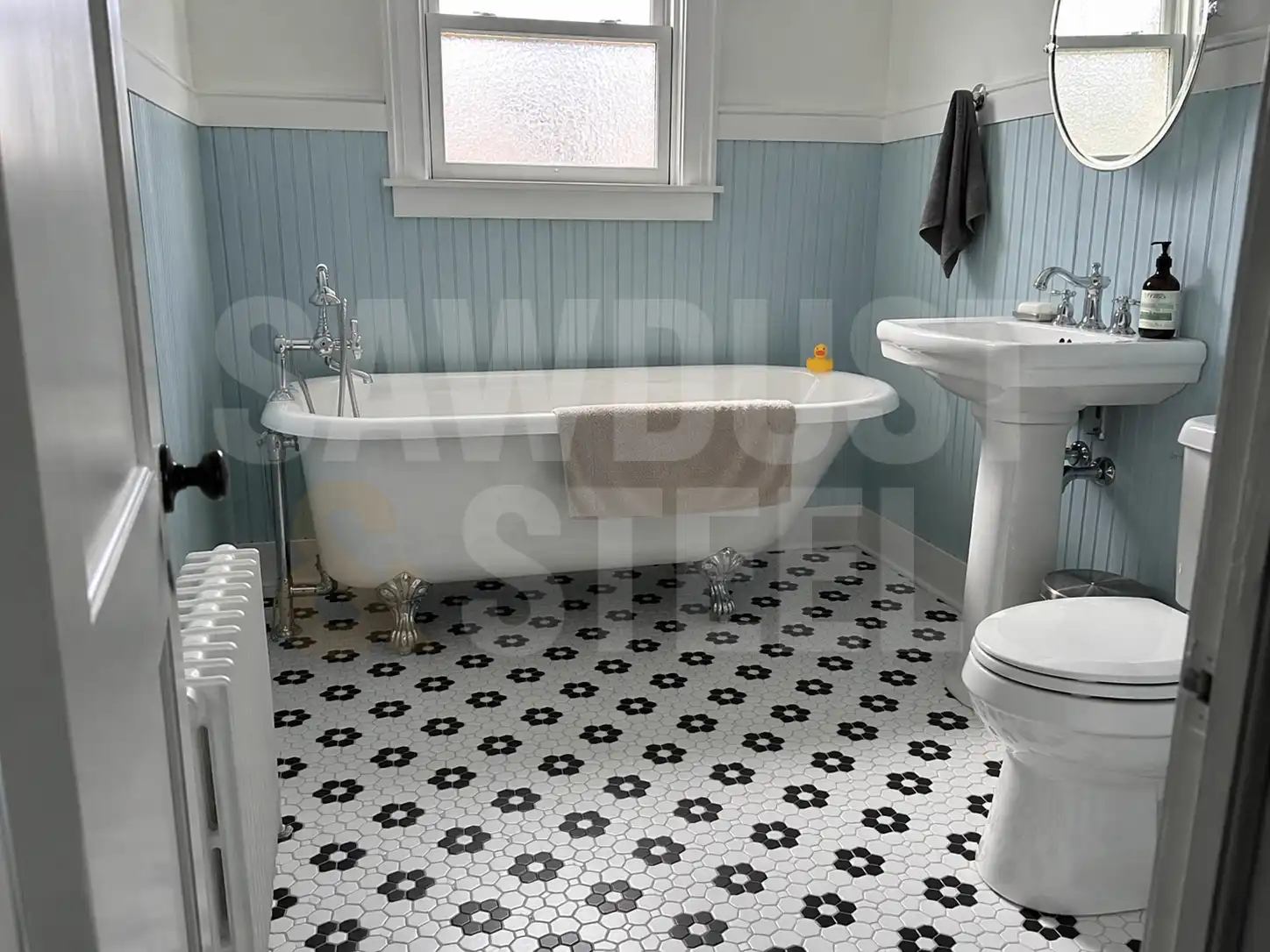 Clawfoot tub with blue beadboard and hexagonal floor tile