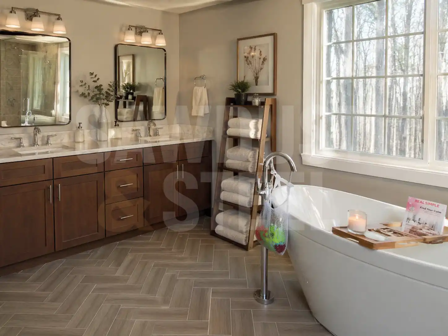 Primary en-suite with freestanding tub, dual vanity, and herringbone tile floor