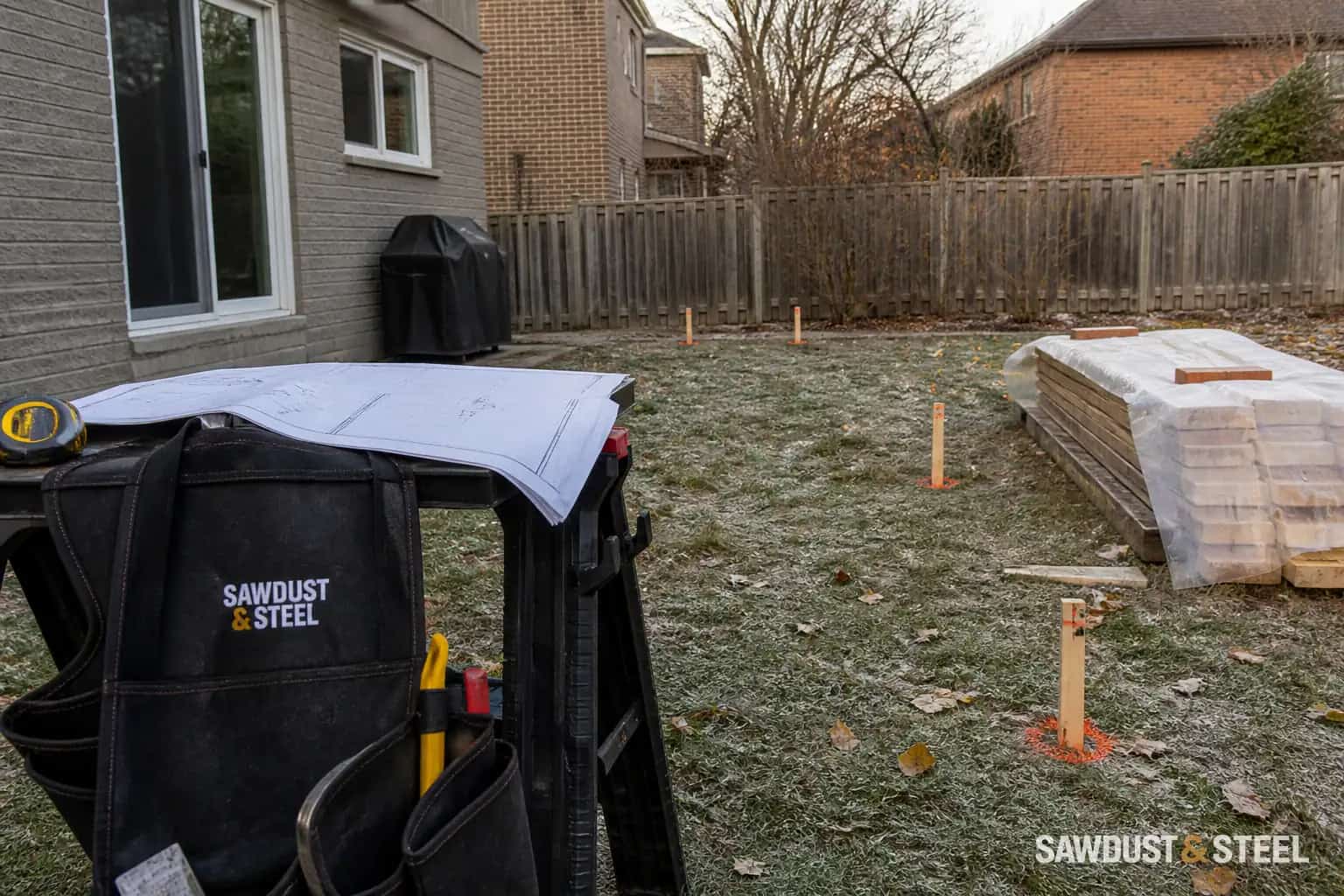 Editorial GTA backyard with deck footing locations marked on frosty ground