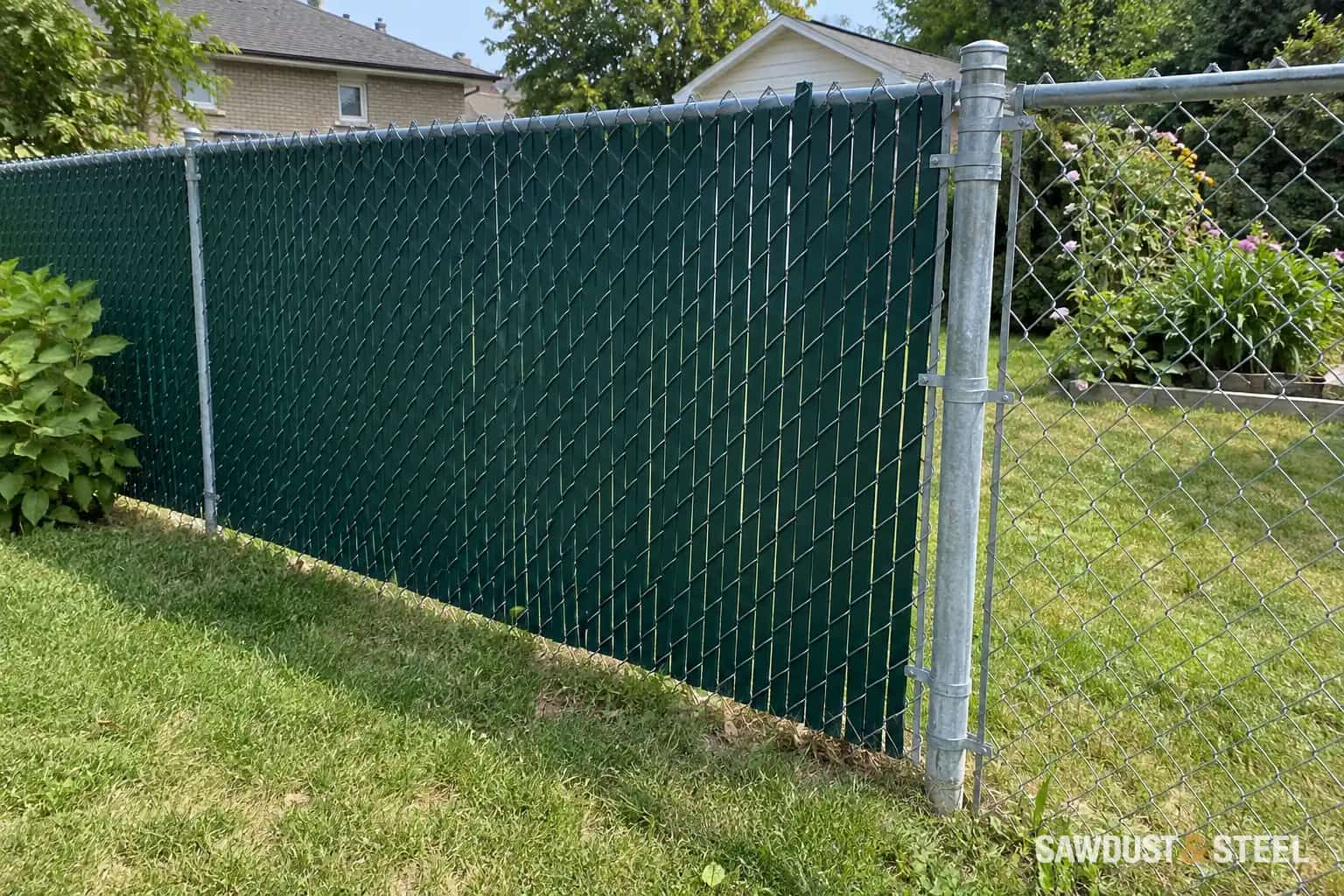 Chain-link fence with privacy slats beside an open section.