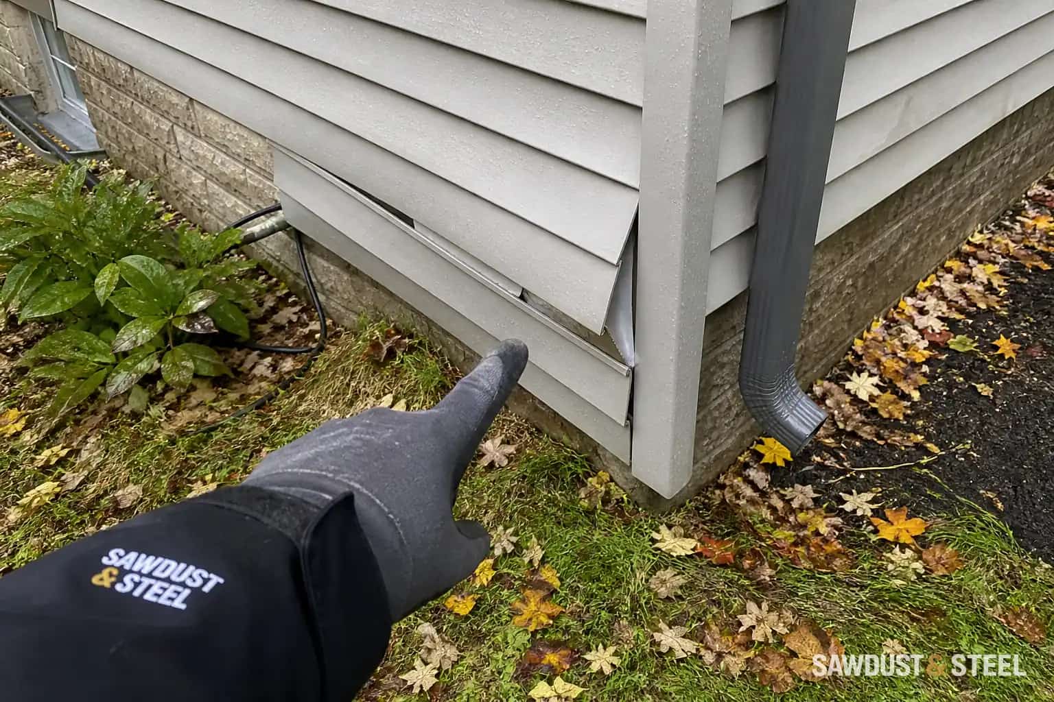 Editorial close view of loose vinyl siding after an autumn storm