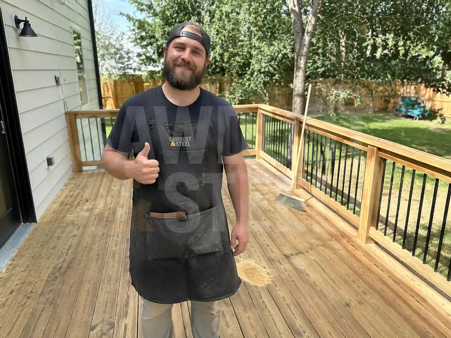 Builder giving thumbs up on a finished new deck