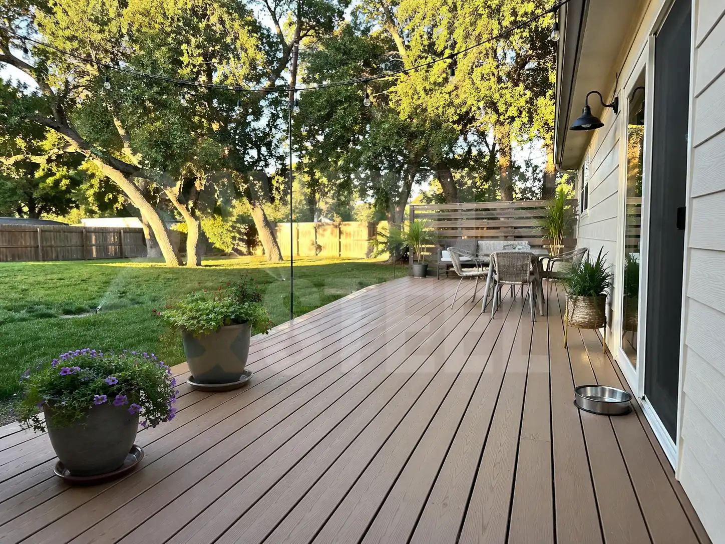 Long composite deck with a view of a landscaped Ontario garden
