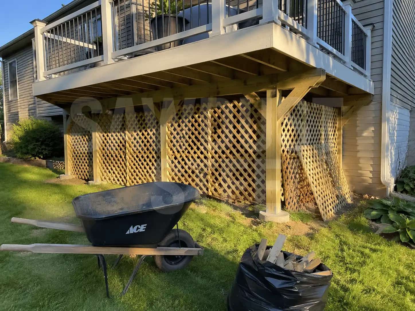 Raised Ontario backyard deck with stairs and lattice skirting