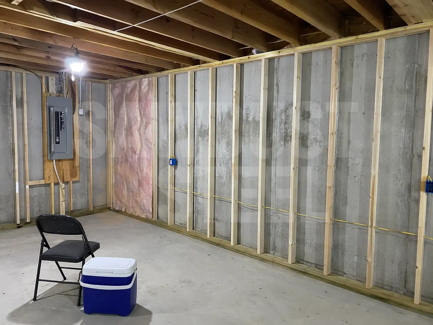 Basement wall studs and insulation panel during a structural project