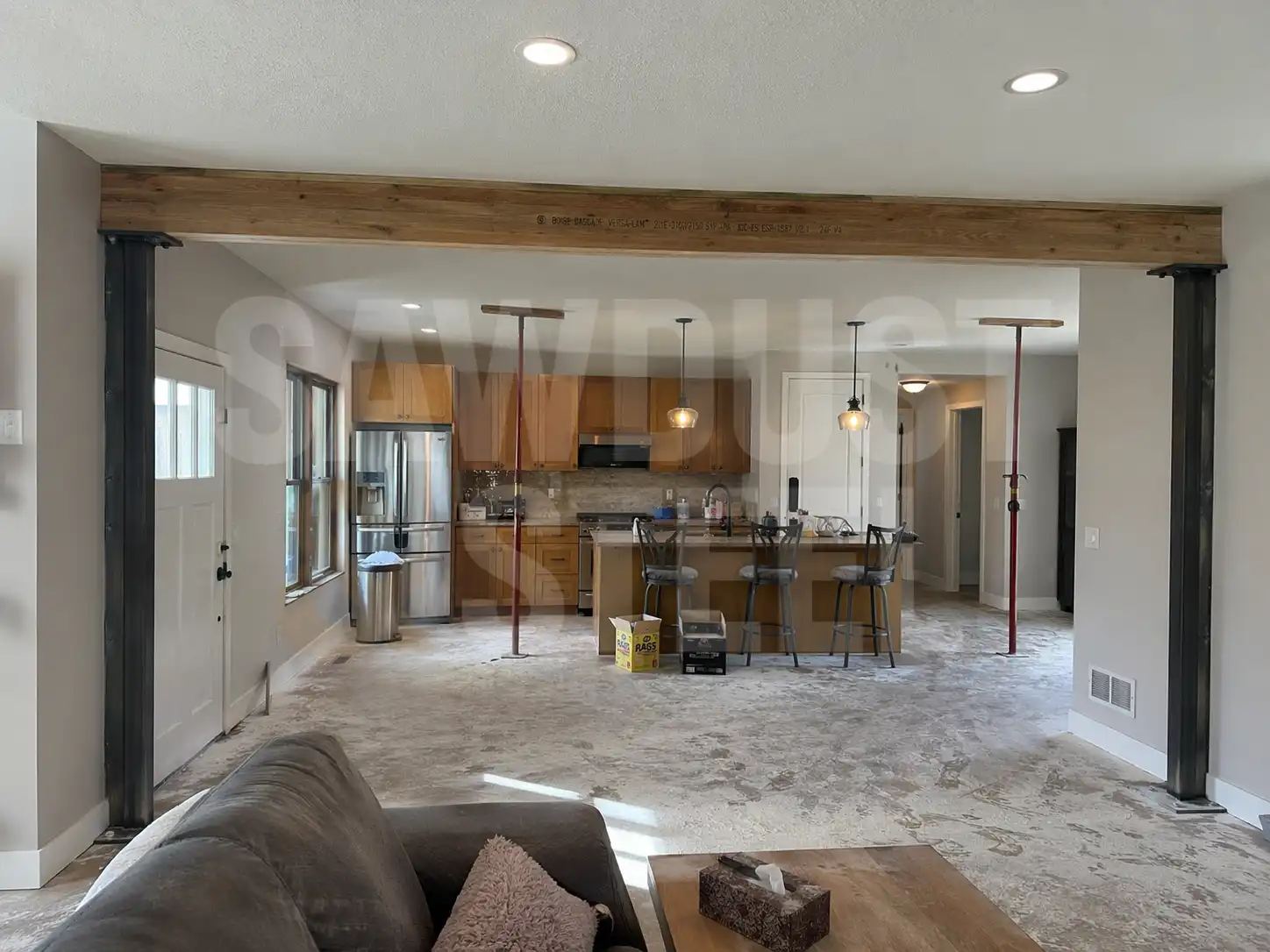 Carpenter work on an exposed beam and steel column in a GTA residential renovation