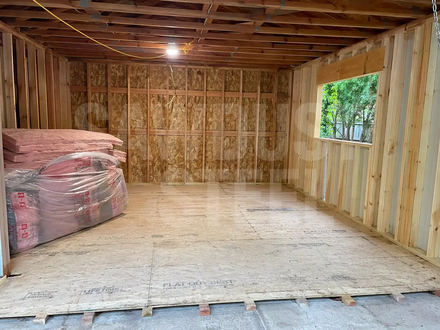 Garage wall framing with OSB sheathing and insulation panel