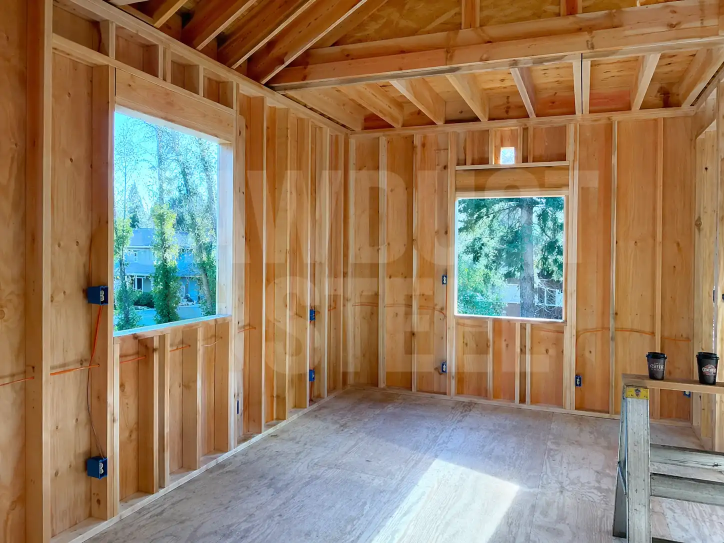 Interior wall studs with framed window openings during a second storey addition