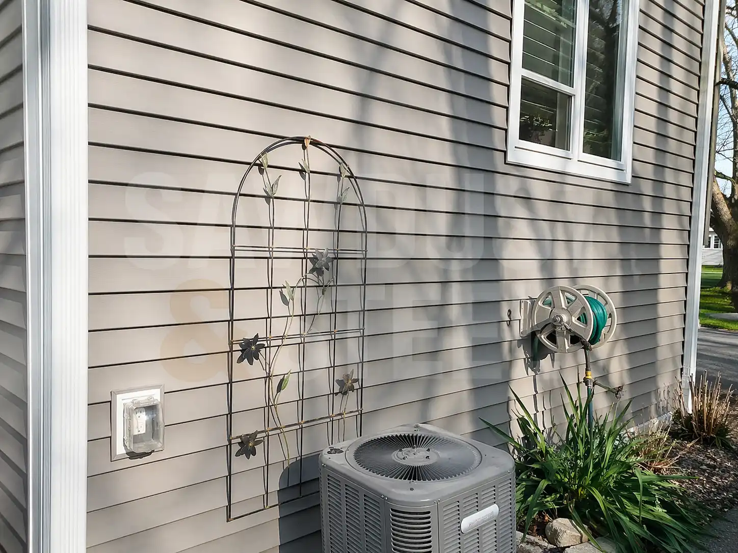 Standing seam metal roof on a gray house with exterior detail
