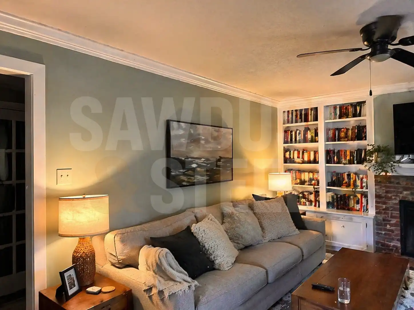 Custom crown molding in a living room above a built-in bookshelf