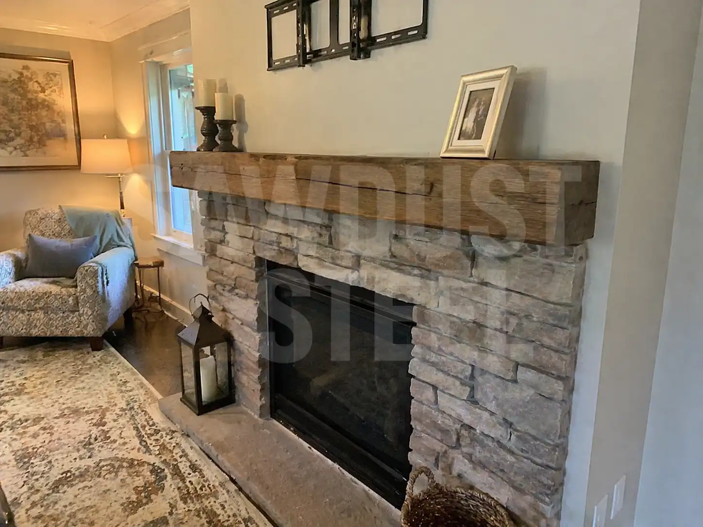 Rustic wood mantel scribed into a stone fireplace surround